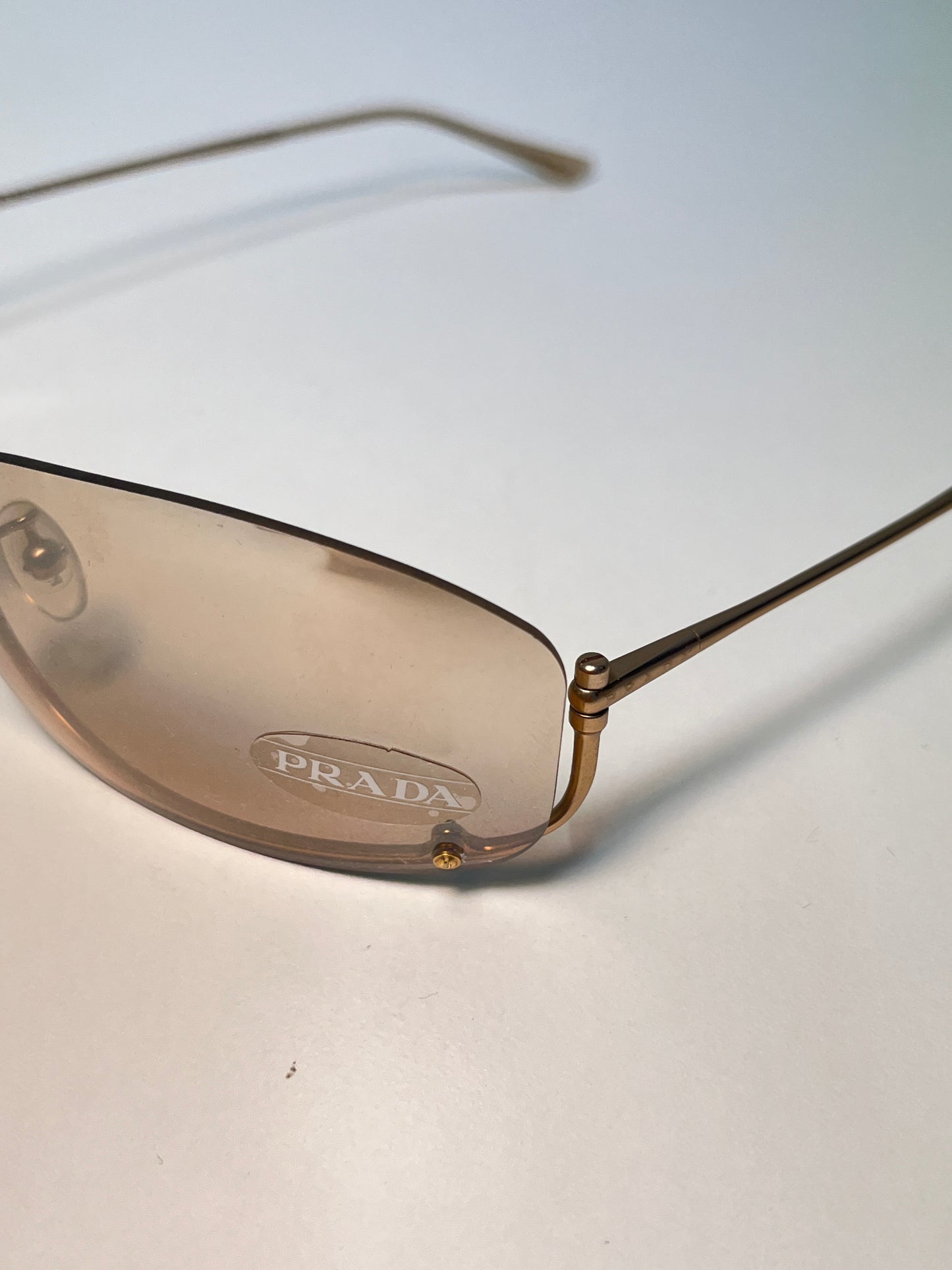 PRADA inverted rose-gold sunglasses