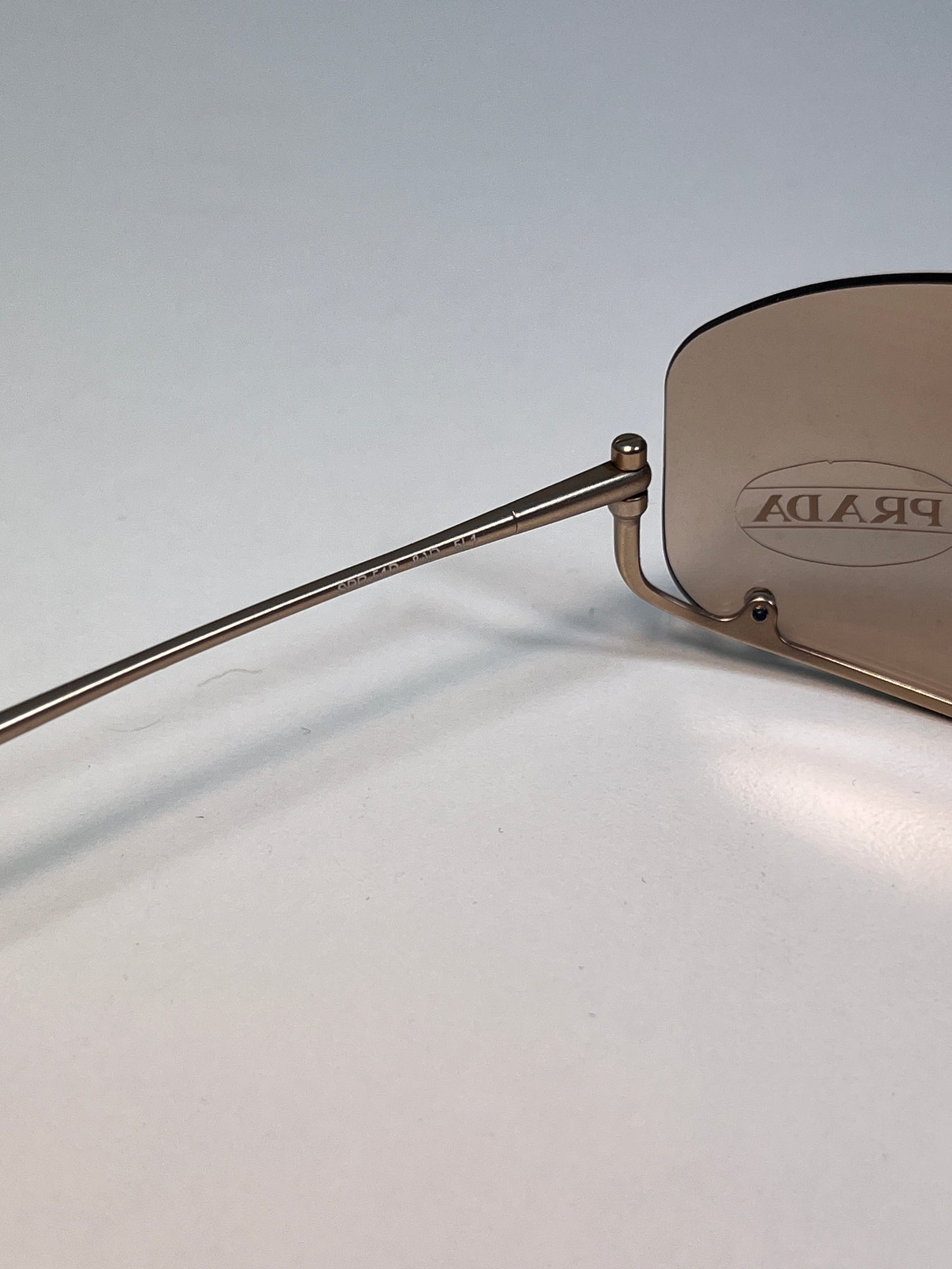 PRADA inverted rose-gold sunglasses