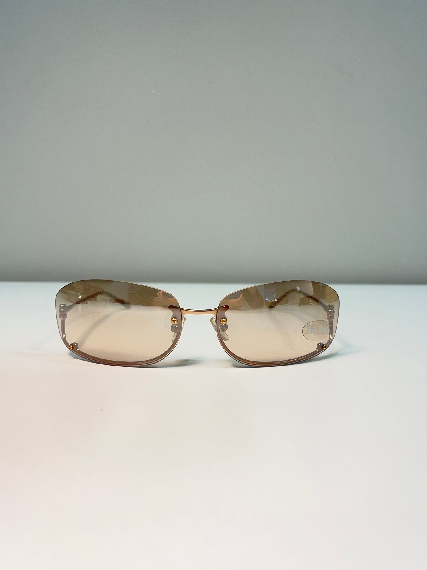 PRADA inverted rose-gold sunglasses
